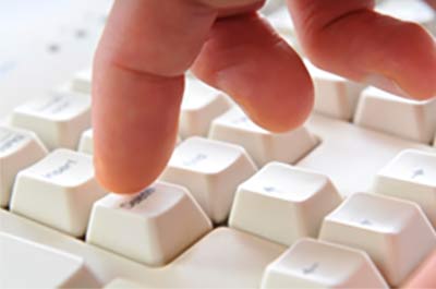 finger pressing key on keyboard